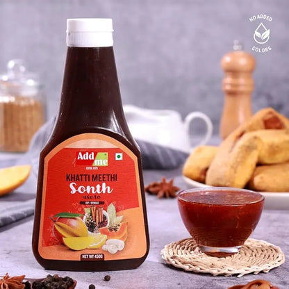 Bottle of Add Me Khatti Meethi Sonth with a bowl of the product on a table.