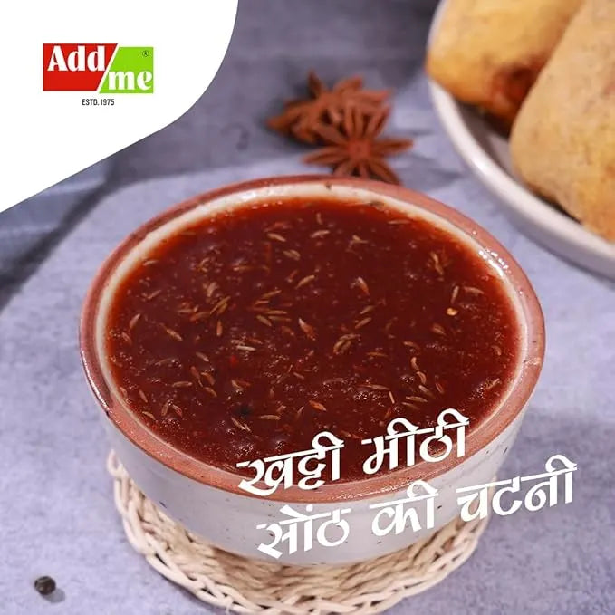 Bowl of chutney with spices on a textured surface, featuring Addme logo.