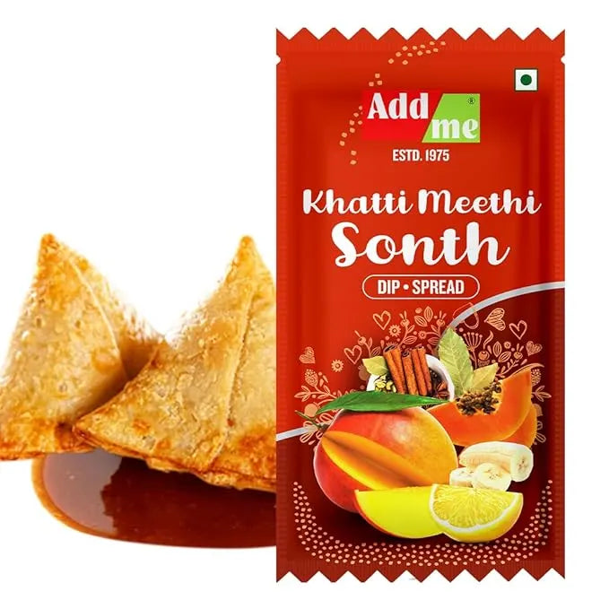 Red packet of 'Add Me Khatti Meethi Sonth' with tortilla chips and dip on a white background