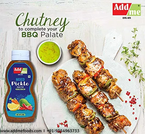 Add Me Mixed Pickle bottle with skewers and chutney on a white background