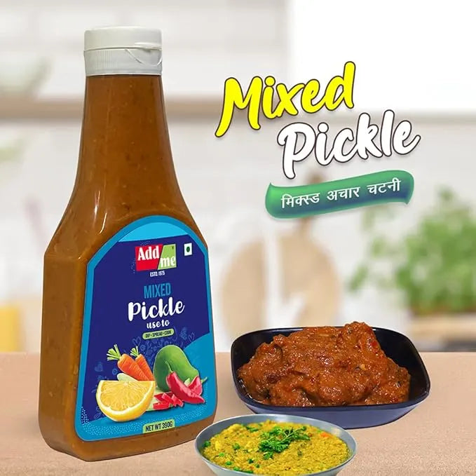Add Me Mixed Pickle bottle with a bowl of pickle and another dish on a table.