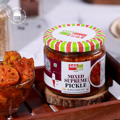 Jar of Add Me Mixed Supreme Pickle on a wooden surface with a bowl of pickled lotus stems.