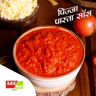 Add Me Foods: Red sauce in a ceramic bowl on a wooden surface with AddMe logo.