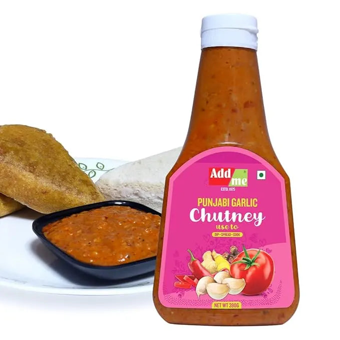 Bottle of Punjabi Garlic Chutney with a pink label, served with bread and chutney on a white plate.