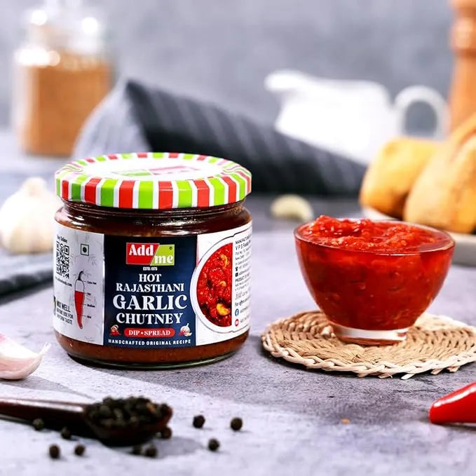 Jar of Adda Hot Rajasthani Garlic Chutney with a bowl of chutney on a table.