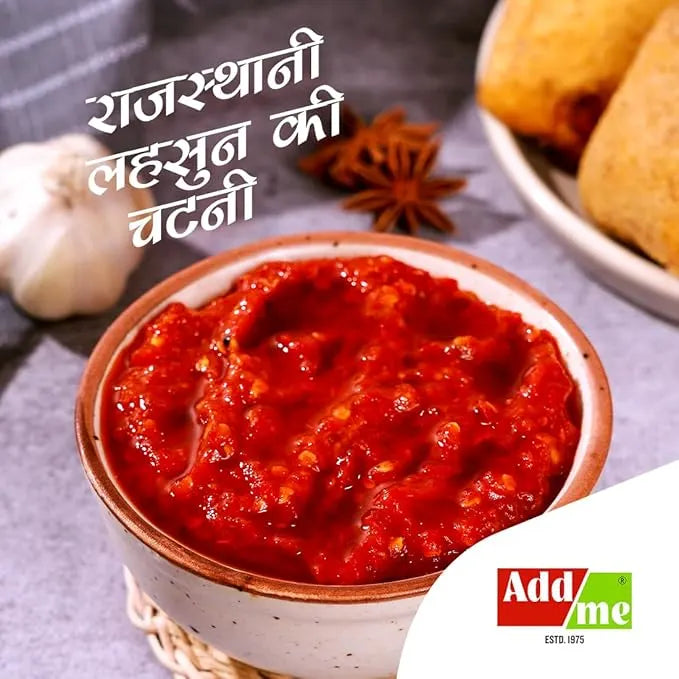 Bowl of red chutney with ingredients and 'Add Me' branding