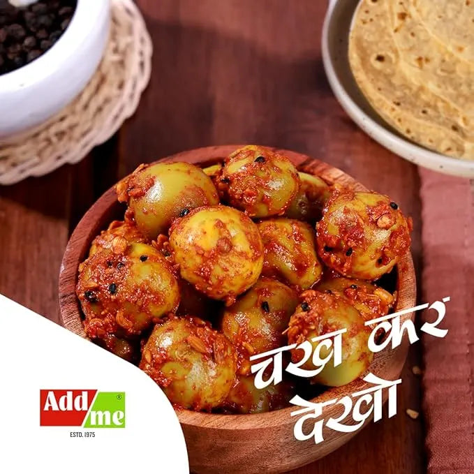 Wooden bowl filled with a spicy green vegetable dish on a wooden table, with 'Add Me' branding.