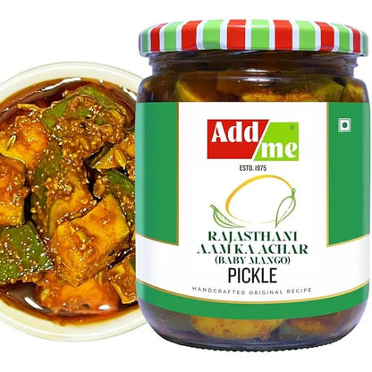 Jar of Add Me Rajasthani Aam Ka Achar pickle with a bowl of curry and green chilies.