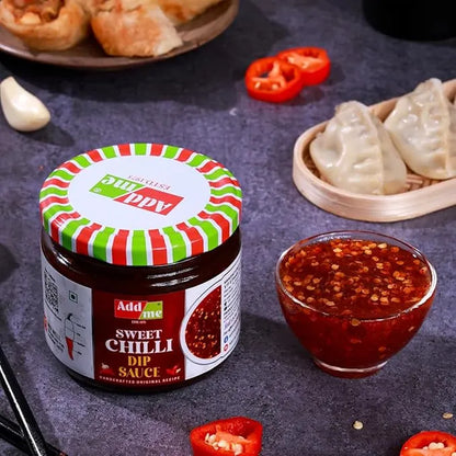 Add Me Foods: Jar of Add some Sweet Chilli Dip Sauce with a bowl of sauce and food items on a dark surface