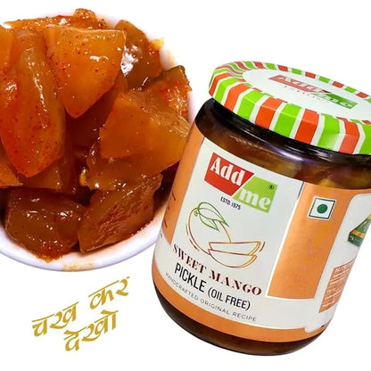 Jar of Add Me Sweet Mango Pickle with a bowl of pickles on a white background