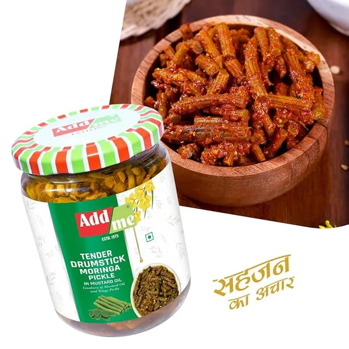 Jar of Add me drumstick moringa pickle with a bowl of pickled vegetables on a wooden surface.