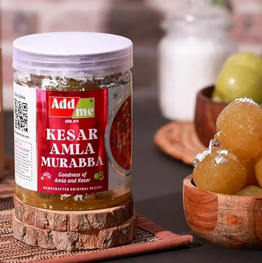 Add Me Foods: Jar of Kesar Amla Murabba with a bowl of preserved fruits on a wooden surface.
